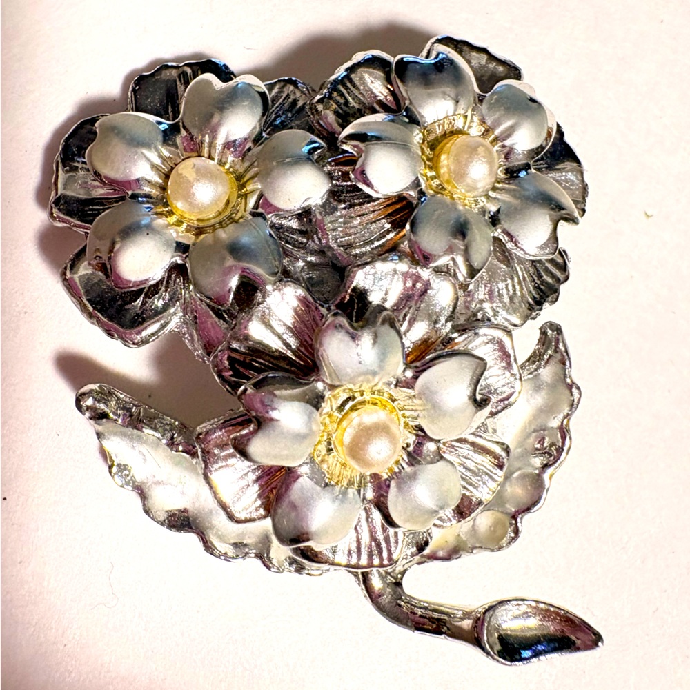 Vintage silver-tone floral brooch likely made in the mid-20th century.